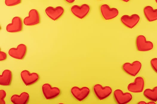 Valentine day yellow paper background with red hearts background. Valentines day or love concept, copy space