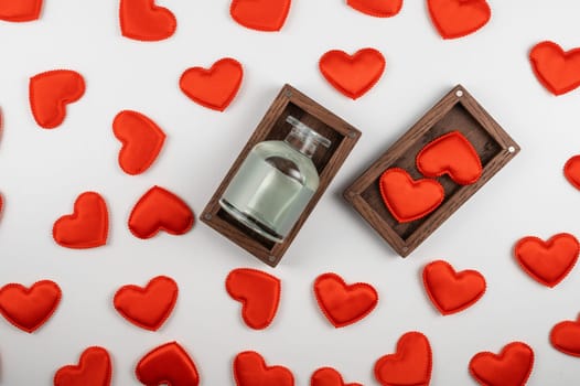 Valentine day white wood background with gift box with perfume bottle with red hearts. Valentines day gift or love concept