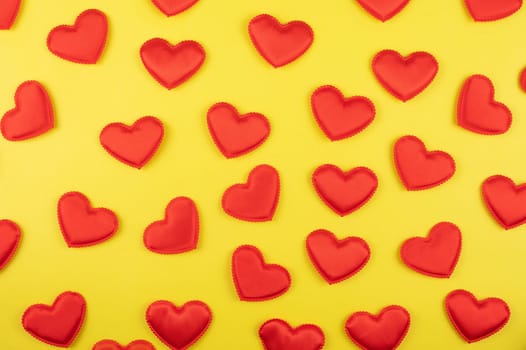 Valentine day yellow paper background with red hearts background. Valentines day or love concept