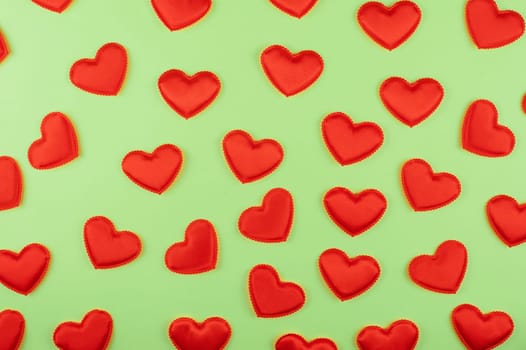 Valentine day green paper background with red hearts background. Valentines day or love concept