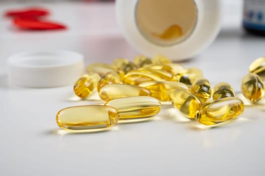 Gold fish oil isolated on white background. Pile of fish oil with Omega 3 acid vitamin D or Vitamin E