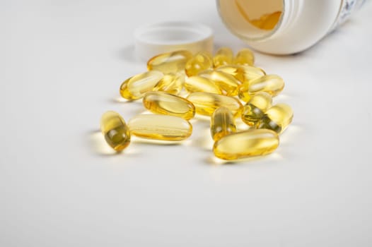 Gold fish oil isolated on white background. Pile of fish oil with Omega 3 acid vitamin D or Vitamin E