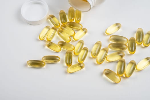Gold fish oil isolated on white background. Pile of fish oil with Omega 3 acid vitamin D or Vitamin E