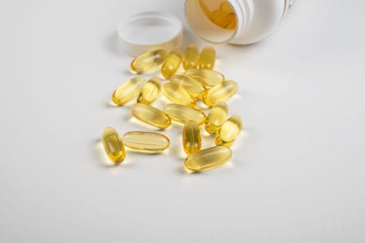 Gold fish oil isolated on white background. Pile of fish oil with Omega 3 acid vitamin D or Vitamin E