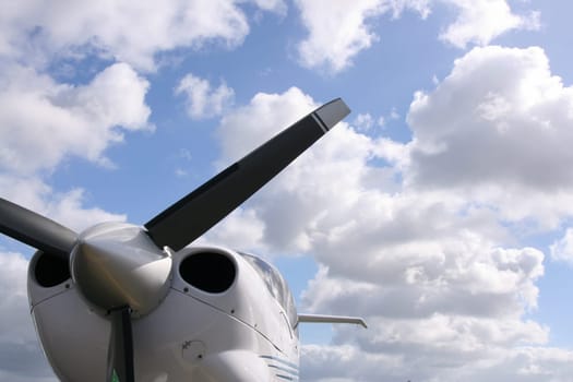 The airplane propeller against cloudy sky