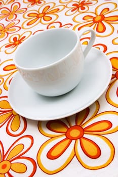 The white coffee cup on the surface with a flower pattern