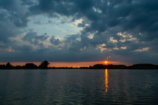 Dark clouds and sunset over the lake, Stankow, Lubelskie, Poland