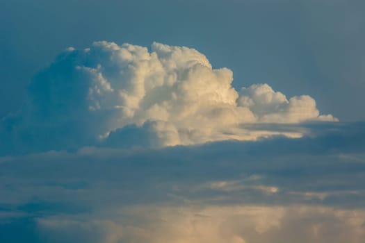 Cumulus clouds against the blue sky, spring day