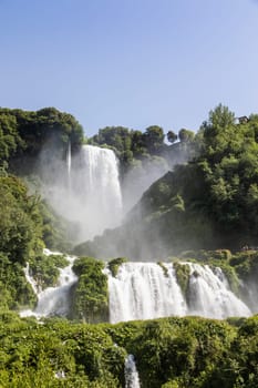 Marmore waterfall in Umbria region, Italy. Amazing cascade splashing into nature with trees and rocks.
