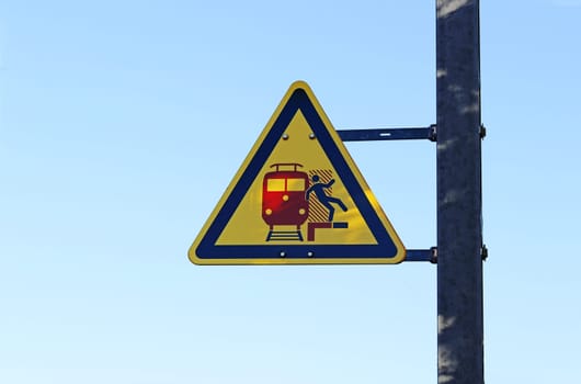 Warning sign at a train station. Attention danger with passing trains