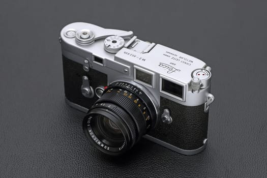 Kagawa, Japan - February 27, 2022: Leica M3 rangefinder camera with Leitz 50mm f2 Summicron M-mount lens. Vintage collectible classic lens concept.