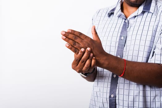 Closeup hand Asian black man holds his palm hand injury, feeling pain, studio shot isolated on white background. Health care and medical office syndrome concept