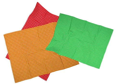 Closeup of a green, brown, red white checkered napkin or tablecloth texture isolated on a white background. Kitchen accessories. Top view.