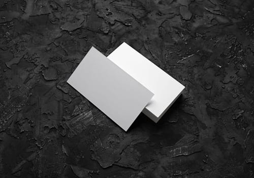 Blank business cards on black stone background. Mockup for branding identity. Template for graphic designers portfolios.