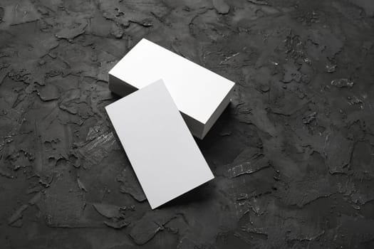 Photo of blank business cards on black stone background. Mock-up for branding identity.