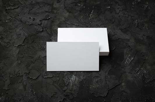 Photo of blank business cards on black stone background. Template for ID.