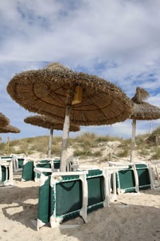 Deck Chairs and Umbrellas on Es Trenc Beach near Ses Salines. Majorca. Spain