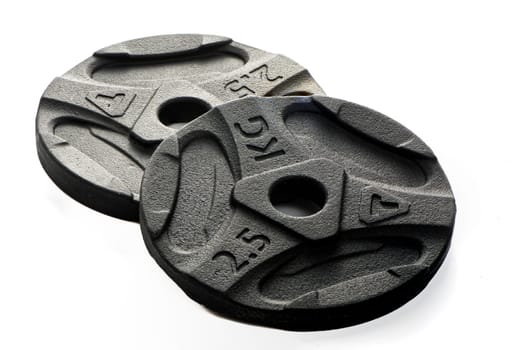 Two black metal pancakes of 2.5 kg each lie on a white isolated background. High quality photo