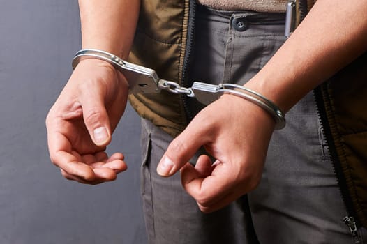 men's hands in metal handcuffs. High quality photo