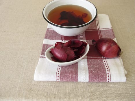 Dye agent, red decoction from red onion peel in a bowl