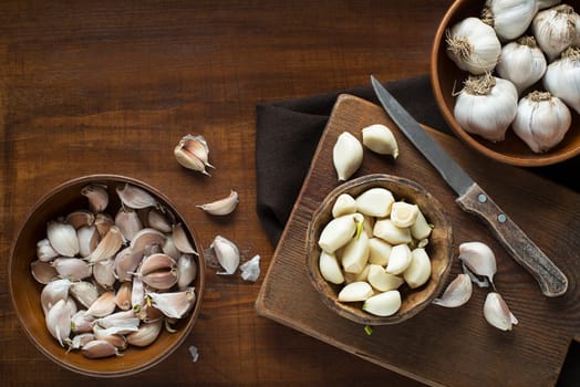 Garlic cloves on wooden vintage background. Garlic cooking