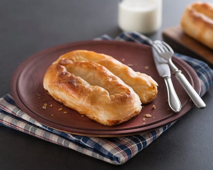 Filled pastry cheese pie served with yogurt. Traditional burek- balkans phyllo pastry pie.