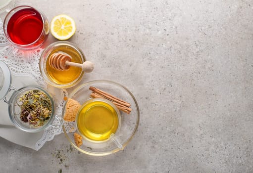 Herbal tea, green tea, fruit tea cups on grey background