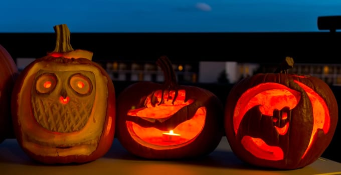 Group of Halloween Jack o Lanterns at night.