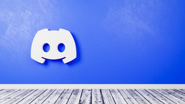 White Discord Logo 3D Symbol Shape on Wooden Floor Against Blue Wall with Copy Space 3D Render Illustration
