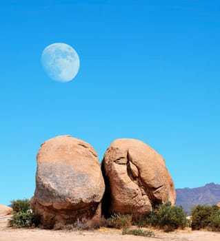 Desert moon over the southwestern USA desert and mountains