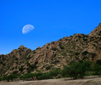 Desert moon over the southwestern USA desert and mountains