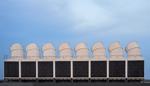 Industrial cooling towers or air cooled chillers on building rooftop