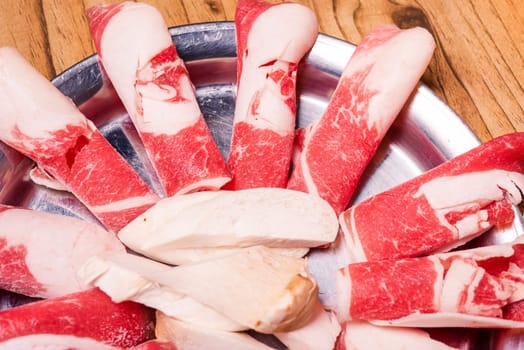 Raw pork on plate, Korean traditional style fresh pork beef belly BBQ, Japanese meat hot pot or Shabu in the restaurant, barbecue food