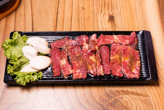 Raw pork on plate, Korean traditional style fresh pork beef belly BBQ, Japanese meat hot pot or Shabu in the restaurant, barbecue food
