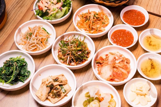 Spicy Kimchi group. Korean pickle or Pickled radish vegetables and seasoning on bowl on wood table background, Japanese food