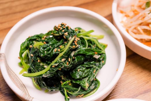 Spicy Kimchi. Korean pickle or Pickled radish vegetables and seasoning on bowl on wood table background, Japanese food