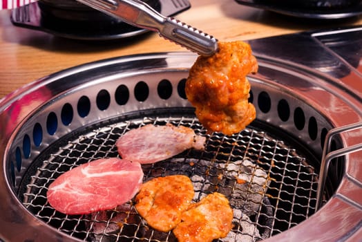Korean beef barbecue on hot coals. Grill meat pork Korean BBQ traditional style on stove serve in restaurant, Japanese food