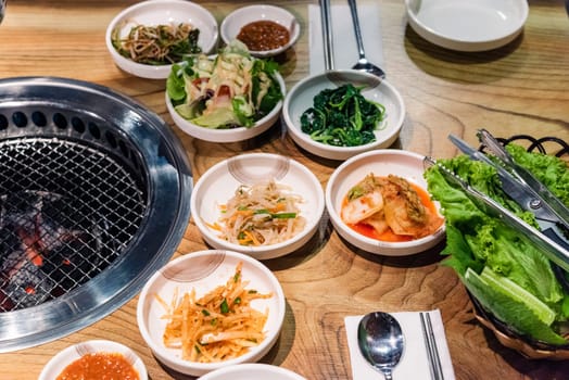 Spicy Kimchi group. Korean pickle or Pickled radish vegetables set and seasoning on bowl on stove serve wood table background, Japanese food