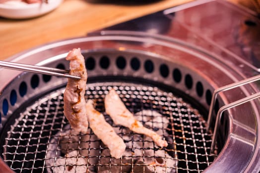 Korean beef barbecue on hot coals. Grilling meat pork Korean BBQ traditional style on stove serve in restaurant, Japanese food