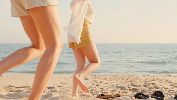 Happy friends holding hands running enjoy life funny and freedom on sand at beach together to sea in holiday vacation time at sunset, Young Asian group woman and man in summer travel, people lifestyle