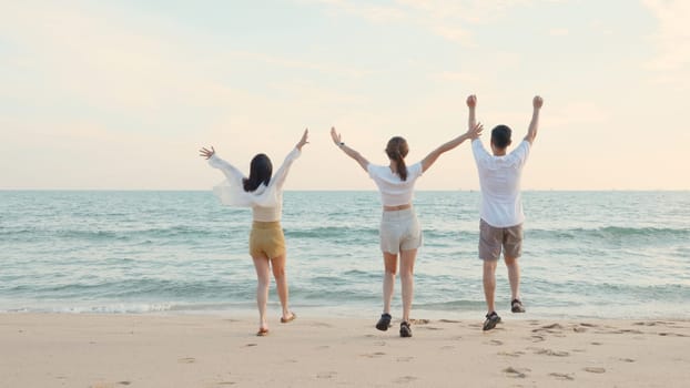 Happy friends holding hands running enjoy life funny and freedom on sand at beach together to sea in holiday vacation time at sunset, Young Asian group woman and man in summer travel, people lifestyle