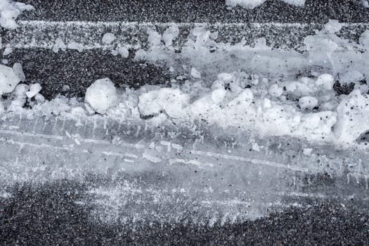 Car tire tracks in fresh snow