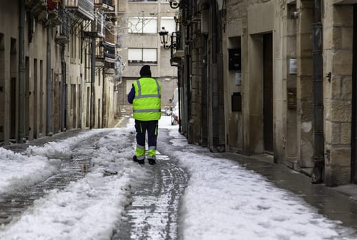 Man cleaning snowy street, winter storm, nature