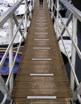 Bridge in fishing port with boats, industry and transport