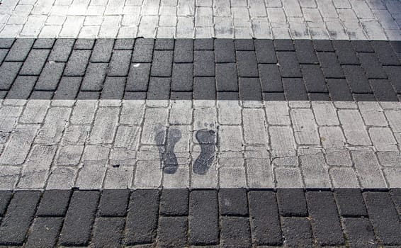 Footprints on city zebra crossing, signs and transport