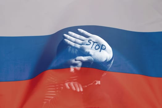 War between Russia and Ukraine. Woman with sad sight, Stop text over Russian flag.