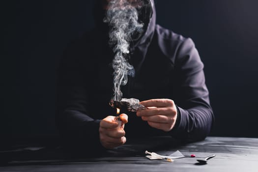 Addict/junkie man preparing drugs. The concept of crime and drug addiction.