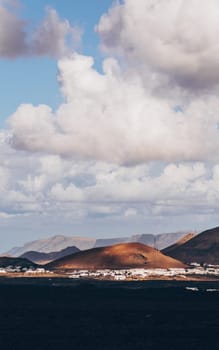 Amazing panoramic landscape of volcano craters in Timanfaya national park. Popular touristic attraction in Lanzarote island, Canary islans, Spain. Artistic picture. Beauty world. Travel concept