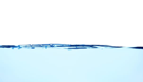 Light blue water wave with air bubbles and a little bit splashed underwater, studio shot isolated on white background. The abstract clean surface on liquid