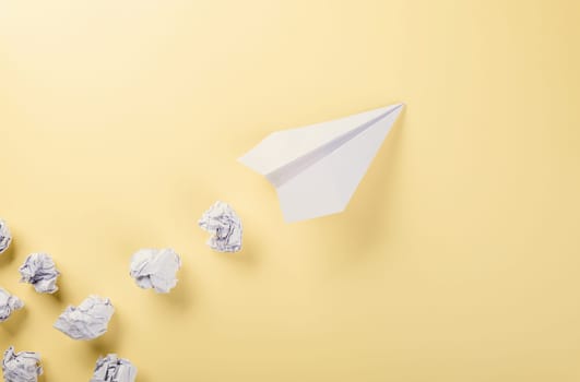 Paper plane letter document message. Top view mock up design of airplane travel, education or innovation origami plane, isolated on yellow background with blank empty space for copy space